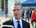 Man in suit on street speaking.