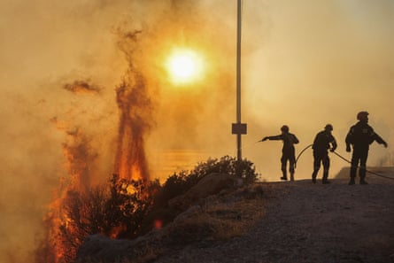 Firefighters try to extinguish a wildfire burning in Saronida, near Athens, Greece, 17 July 2023.