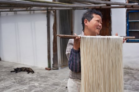 Zhihu Fu, 56, the town’s noodle maker in the courtyard of her family’s historic home, China