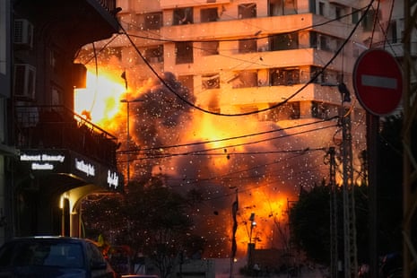 An explosion erupts from a building after an Israeli strike in central Beirut