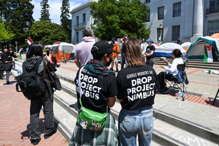 people wear shirts that read ‘Google workers say drop project nimbus’
