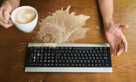 Man spilling coffee on a keyboard