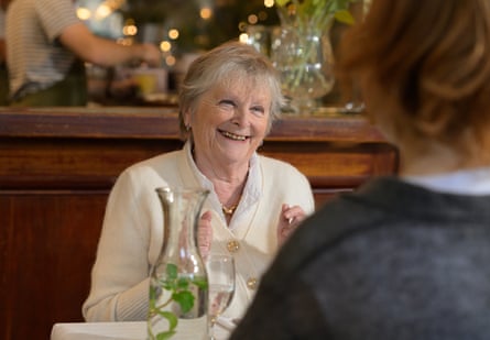Moira smiling at Ruth at a restaurant table