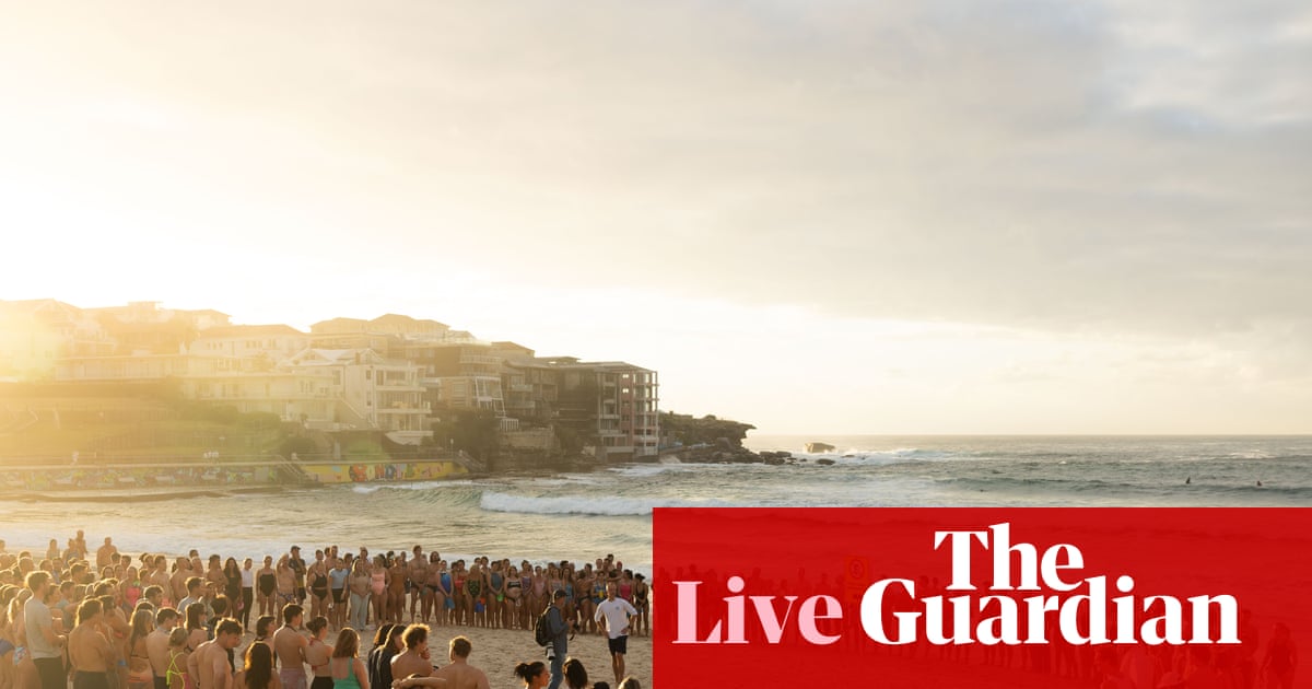 Bondi terror attack updates: swimmers honour victims at dawn vigil; John Howard is ‘trying to diminish’ importance of tighter gun laws, Chalmers says