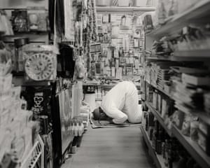 Irfan Ali performs his daily prayers in the aisles of his corner shop during lockdown, 2020