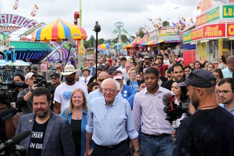 Bernie Sanders and his wife walk along the midway at the Iowa State Fair.