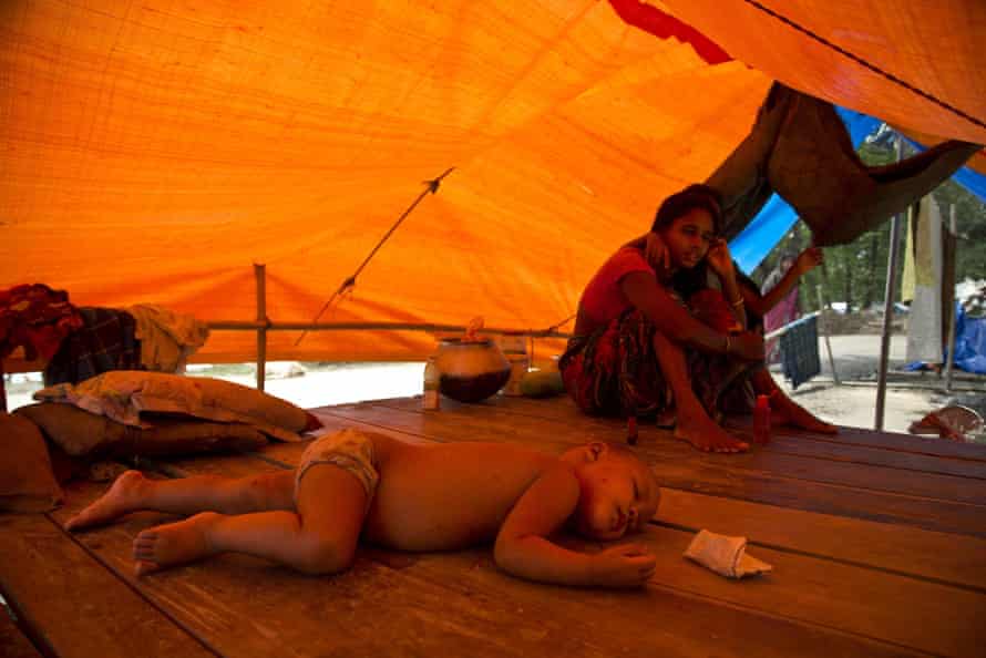 A family takes shelter in a roadside tent in Morigaon district, Assam, India
