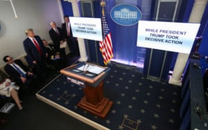 Donald Trump watches a multimedia presentation created by the White House to defend the president’s response to the coronavirus outbreak.