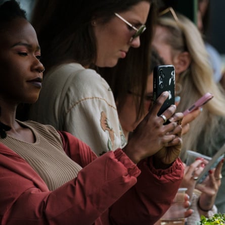 A racegoer uses her phone at Ngong Racecourse.
