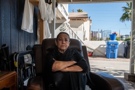A woman sitting in a chair with her arms crossed across her chest