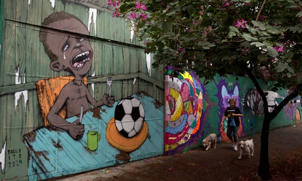 A mural in Sao Paulo by street artist Paulo Ito, created ahead of the 2014 World Cup in Brazil, shows a crying child with only a football to eat