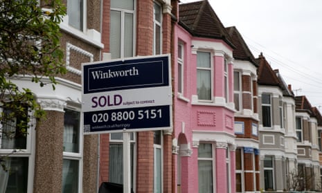 An estate agent’s ‘Sold’ sign outside a terraced house in London. An average property cost £254,624 in May.