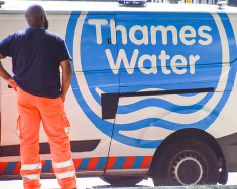 A worker stands next to a Thames Water van in central London