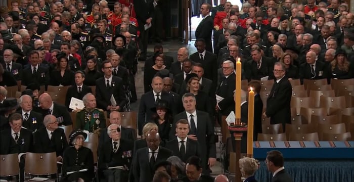 Macron is seen among other guests arriving ahead of the funeral service.