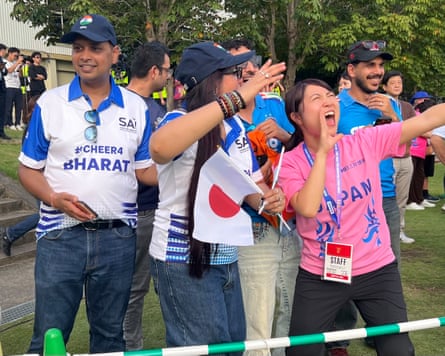 Fans cheer on the sidelines