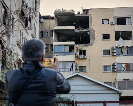 A man takes pictures of the damage in an apartment building after it was hit by an Israeli airstrike in Dahieh, Beirut’s southern suburb, on 2 March 2026.