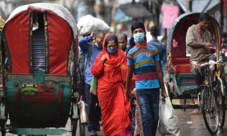 People wearing face masks on a street in Dhaka, Bangladesh.