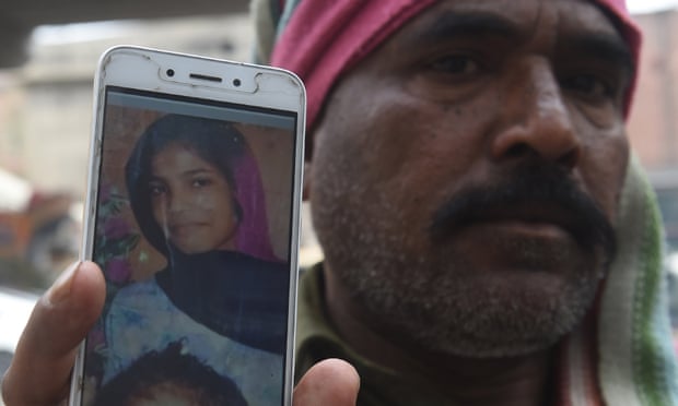 Muhammad Riaz shows a photo of his daughter, 16-year-old Uzma Bibi, who was allegedly tortured and murdered by her employer in Lahore
