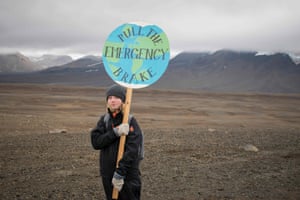 A girl poses with a placard walks to the plaque site.