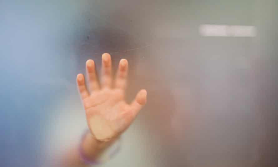 Close up of little girl’s hand against glass