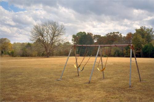 Swinging in the Wind Behind a Place of Worship, ArkansasThrough the Bible Belt I saw places that recalled Malick’s Days of Heaven. I wandered around the back of a church and remembered a hundred similar scenes in rural South Australia. What was the difference? I ruminated. The answer came to me as I framed the shot. In Australia, there is a comical context for much of what is sacred and profane; there is mocking, there is “piss-taking” there is satire and irony. In America, religion is not treated this way outside the bi-coastal megacities. Religion is everything, is all encompassing and not to be made fun of. I laughed as I pressed the shutter.