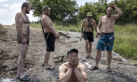 Ukrainian servicemen baths in a stream in the Fedorivka frontline, Ukraine.