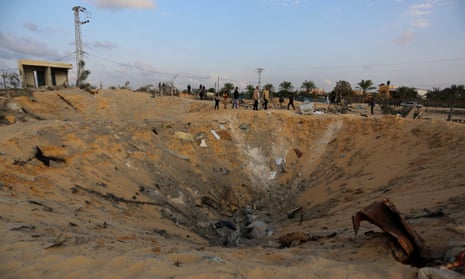 Palestinians inspect a huge hole after Israeli airstrikes hit the residential area of Deir al Balah, Gaza, on Friday. The Israeli military says it is “currently striking Hamas terror targets” in Gaza.