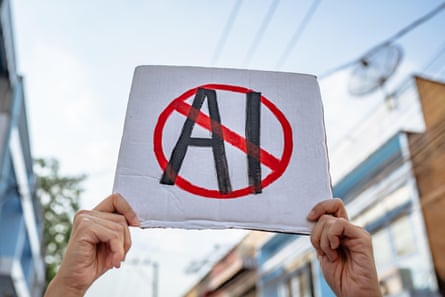 demonstrator holds sign that says “no AI”
