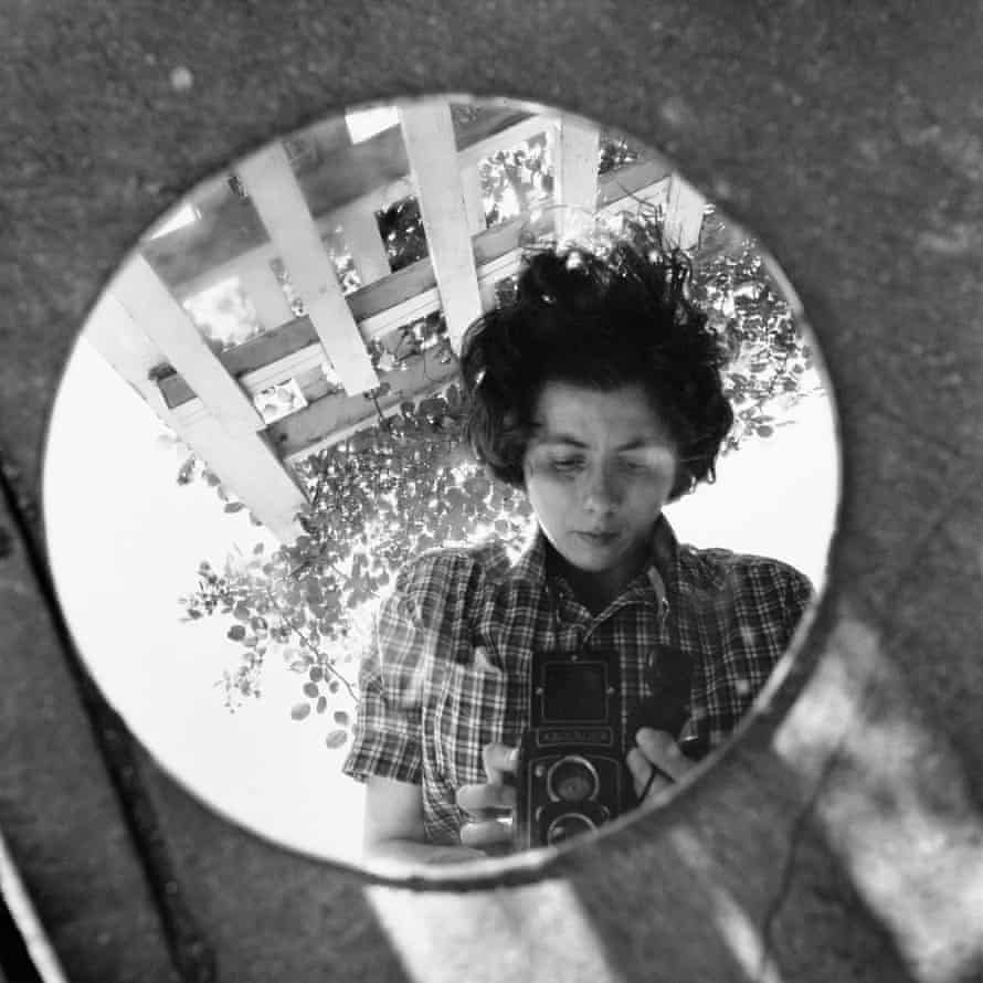 Self-portrait, reflected in round mirror, New York, 1953.