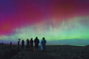 People watch the aurora borealis over the Hebrides in Scotland