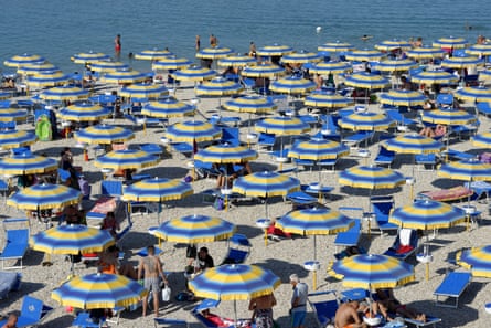 People under lots of parasols on a beach