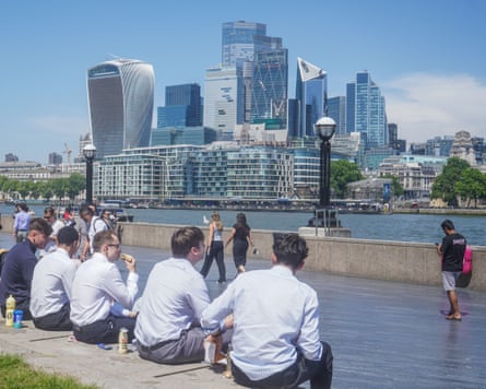 City workers relaxing in the sunshine during a lunch break in Potters Field on another sweltering day in London