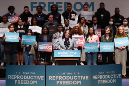 Kamala Harris with people behind her and signs saying fighting for reproductive freedom
