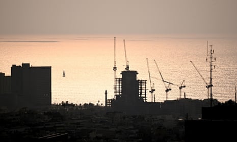 Cranes under the sunset in Tel Aviv amid the ongoing conflict between Israel and Hamas