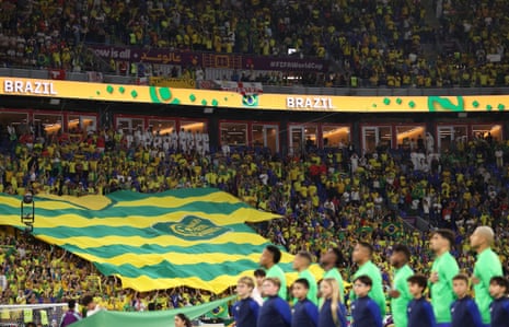 Brazil fans display a giant shirt promoting the Verde Amarelo supporters’ movement.
