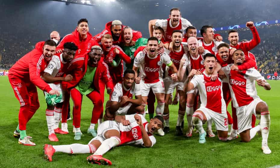 The Ajax players enjoy themselves on the pitch after qualifying for the Champions League knockout stage with their fourth straight win, this time at Borussia Dortmund.