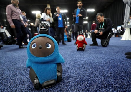 Lovot companion robots by Groove X wander in front their booth at CES.