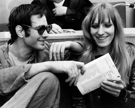 A man in shades looks fondly at a woman with long blond hair