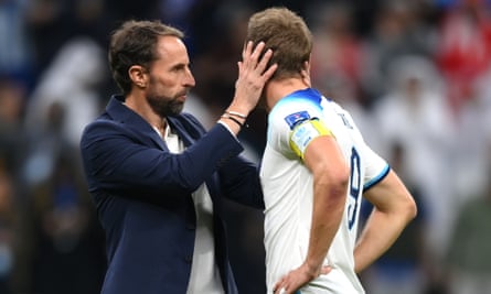 Harry Kane of England is consoled by Gareth Southgate after losing to France in the 2022 World Cup quarter-final