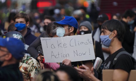 People take part in a climate protest in Times Square in New York on Sunday.