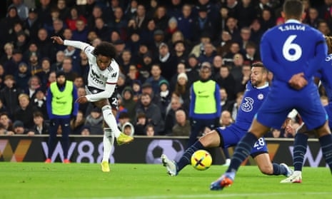 Willian's shot is deflected into the bottom corner.