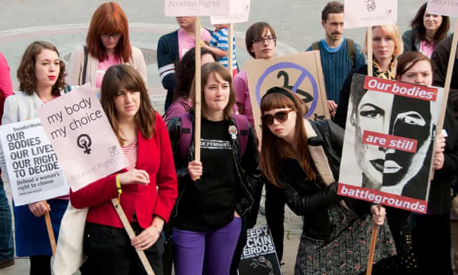Pro-choice campaigners holding a rally opposite the Houses of Parliament in London