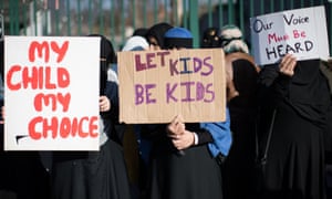 Parents protest outside the school.