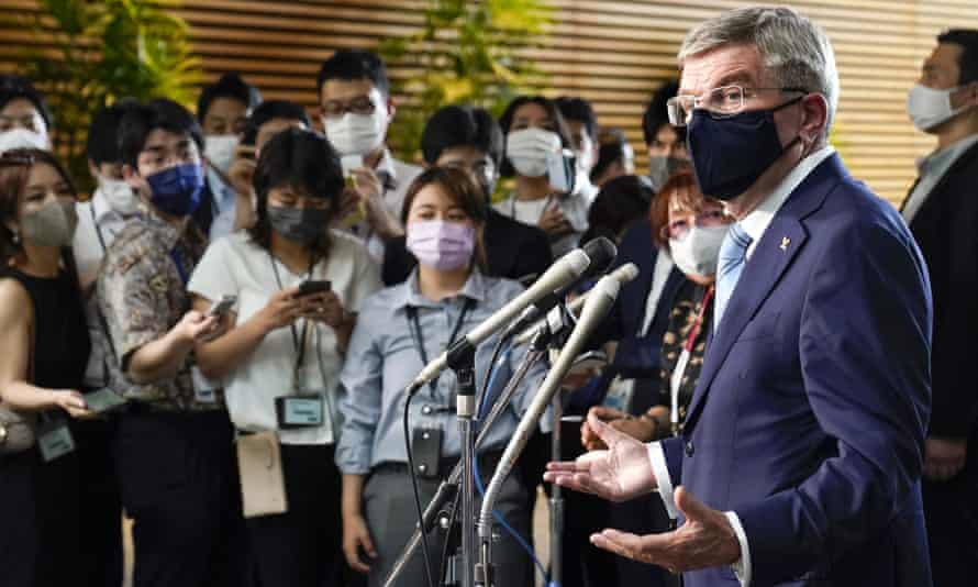 International Olympic Committee president Thomas Bach, right, speaks to journalists after meeting Japanese Prime Minister Yoshihide Suga in Tokyo on Wednesday.