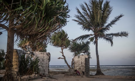 A girl playing at the remains of an abandoned house
