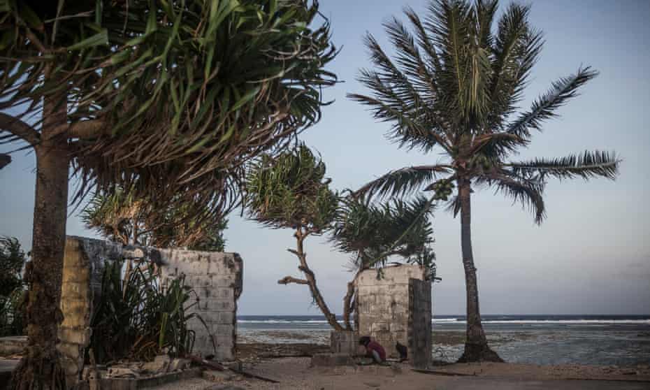 A girl playing at the remains of an abandoned house