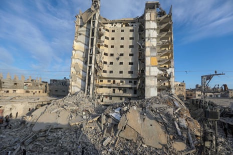 Debris is seen around the damaged Al-Masry Tower after Israeli airstrikes on Saturday in Rafah, Gaza.