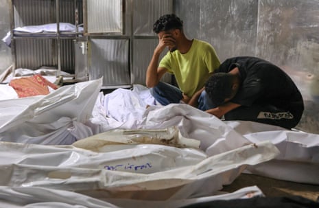 The bodies of dead Palestinian people lay at the morgue of al-Shifa hospital in Gaza City.