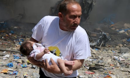 A rescued baby from what activists said was a site hit by a barrel bomb dropped by forces loyal to Syrian president Bashar al-Assad in Aleppo.