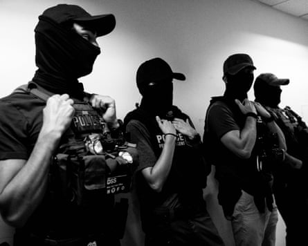 black and white photo of a row of federal agents in uniform